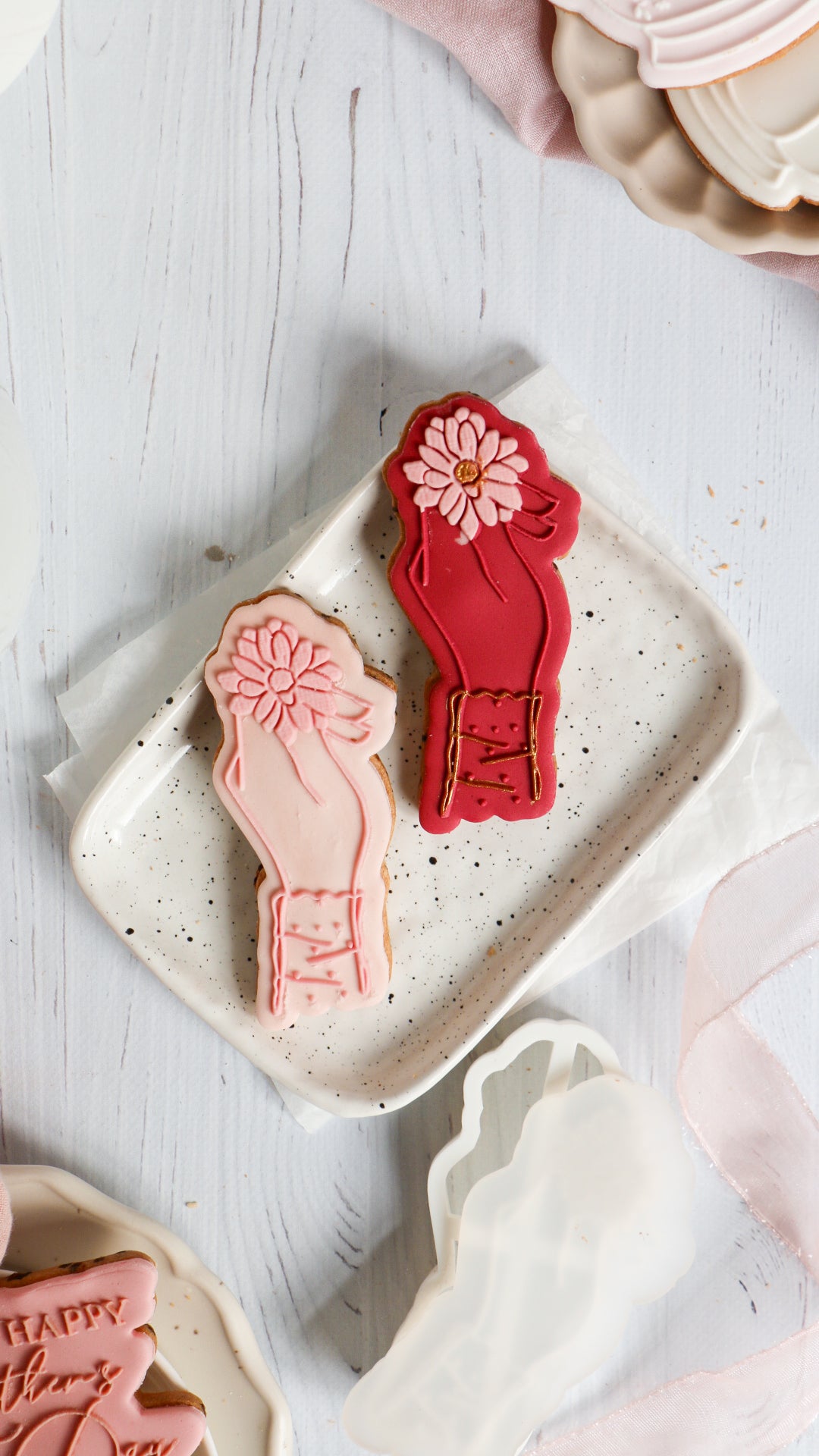 Hand holding flower + cookie cutter